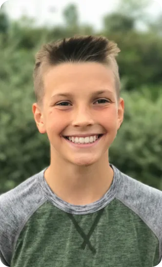 Young boy smiling outside