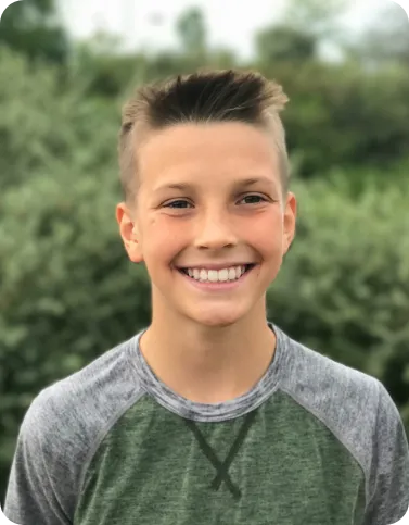 Young boy smiling outside