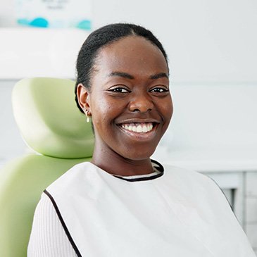 Woman smiling while sitting in treatment chair