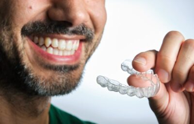 Man smiling after removing his aligners.
